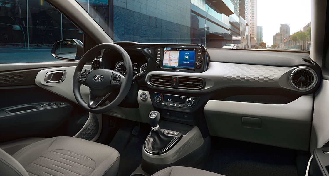 Sporty dashboard design. A new 3D honeycomb pattern is featured on the dashboard and door panels for a sporty edge. The circular air-vents visually extend the dashboard into the door trim for a wider, more spacious feeling.